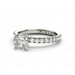 Round cut claw set diamond ring with pave set side stone in 18K White