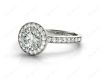 Round cut halo diamond engagement ring with four claw setting in Platinum