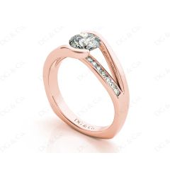 Round Cut Cross Over Ring Half Bezel Set Diamond Engagement Ring with Channel Set Side Stones in 18k Rose