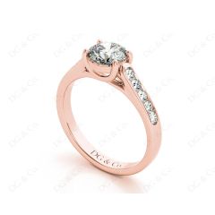 Round Cut 4 Claw Side Stone Engagement Ring with Channel Set Side Stones in 18K Rose