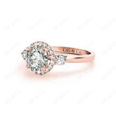 Round Cut Halo Trilogy diamond ring with pave set side stone in 18K Rose