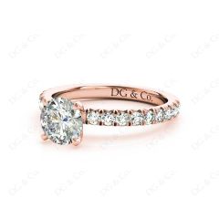 Round cut claw set diamond ring with pave set side stone in 18K Rose