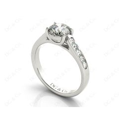 Round Cut 4 Claw Side Stone Engagement Ring with Channel Set Side Stones in Platinum