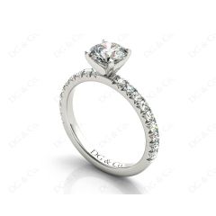 Round cut claw set diamond ring with pave set side stone in Platinum