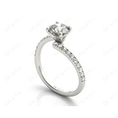 Round cut diamond cross over ring claw set diamond with pave set side stone in Platinum