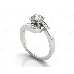 Round Cut Four Claw Set Diamond Ring with Channel Set Stones Down the Shoulders in Platinum