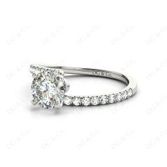 Round cut diamond cross over ring claw set diamond with pave set side stone in Platinum