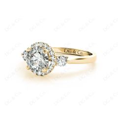 Round Cut Halo Trilogy diamond ring with pave set side stone in 18K Yellow