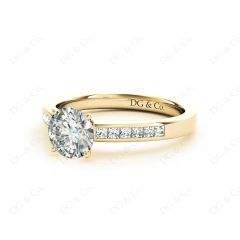 Round cut diamond ring with four claws set centre stone in 18K Yellow