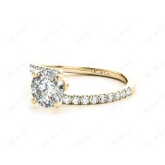 Round cut diamond cross over ring claw set diamond with pave set side stone in 18K Yellow