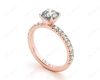 Round cut claw set diamond ring with pave set side stone in 18K Rose