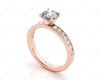 Round Cut Four Claw Set Diamond Ring with Channel Set Side Stones Down the Shoulders in 18k Rose