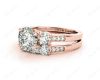 Round Cut Diamond trilogy wedding set rings with claw set side stone in 18K Rose