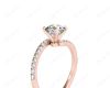 Round cut diamond cross over ring claw set diamond with pave set side stone in 18K Rose