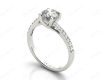 Round Cut Four Claw Set Diamond Ring with Pave Set Diamonds Down the Shoulders in 18K White