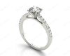 Round Cut Four Claw Set Diamond Ring with Round Pave Set Stones Down the Shoulders in Platinum