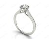 Round Cut Four Claw Set Diamond Ring with Round Cut Channel Set Diamonds Down the Shoulders and on the Setting in Platinum