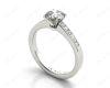 Round cut diamond ring with four claws set centre stone in Platinum