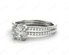 Round Cut Four Double Claw Set Diamond Ring with Pave Set Diamonds Down The Shoulders in Platinum