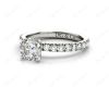 Round cut claw set diamond ring with pave set side stone in Platinum