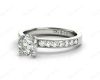 Round Cut Four Claw Set Diamond Ring with Channel Set Side Stones Down the Shoulders in 18k White Gold