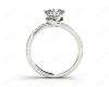 Round Cut Split Shank Diamond Engagement Ring with a Twist Band and Pave Set Side Stones in Platinum