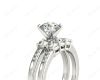 Round Cut Diamond trilogy wedding set rings with claw set side stone in Platinum