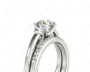 Round cut diamond wedding set rings with channel set shoulders in Platinum