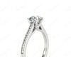 Round Cut Four Claw Set Diamond Ring with Round Cut Channel Set Diamonds Down the Shoulders and on the Setting in Platinum