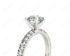 Round cut claw set diamond ring with pave set side stone in Platinum