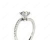 Round cut diamond cross over ring claw set diamond with pave set side stone in Platinum