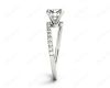 Round cut diamond cross over ring claw set diamond with pave set side stone in Platinum