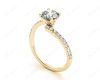 Round cut diamond cross over ring claw set diamond with pave set side stone in 18K Yellow