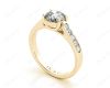 Round Cut 4 Claw Side Stone Engagement Ring with Channel Set Side Stones in 18K Yellow