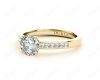 Round cut diamond ring with four claws set centre stone in 18K Yellow