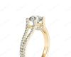 Round cut diamond ring with claw set centre stone in 18K Yellow