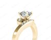 Round Cut Four Claw Set Diamond Ring with Channel Set Stones Down the Shoulders in 18k Yellow