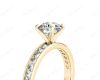 Round Cut Four Claw Set Diamond Ring with Channel Set Side Stones Down The Shoulders in 18k Yellow Gold