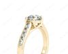 Round Cut 4 Claw Side Stone Engagement Ring with Channel Set Side Stones in 18K Yellow