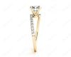 Round cut diamond cross over ring claw set diamond with pave set side stone in 18K Yellow