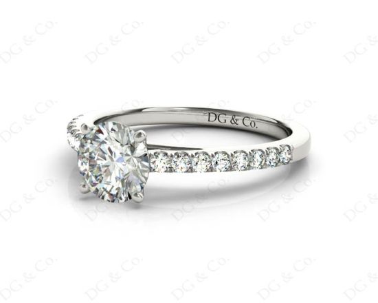 Round Cut Four Claw Set Diamond Ring with Round Pave Set Stones Down the Shoulders in Platinum