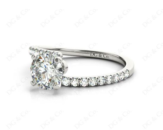 Round cut diamond cross over ring claw set diamond with pave set side stone in Platinum