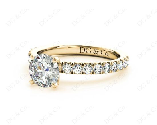 Round cut claw set diamond ring with pave set side stone in 18K Yellow