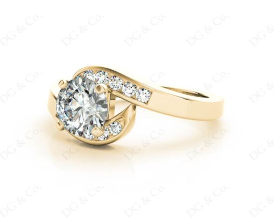 Round Cut Four Claw Set Diamond Ring with Channel Set Stones Down the Shoulders in 18k Yellow