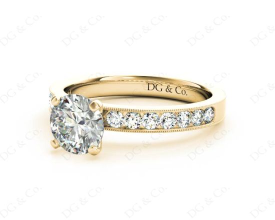 Round Cut Four Claw Set Diamond Ring with Channel Set Side Stones Down The Shoulders in 18k Yellow Gold